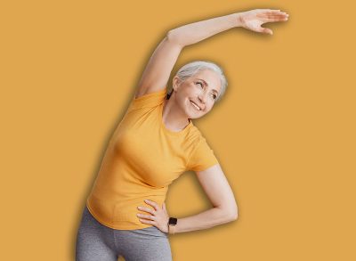 Sport on retirement. Happy senior woman doing flexibility exercises for healthier living during home workout, female leading sporty lifestyle, training in living room interior