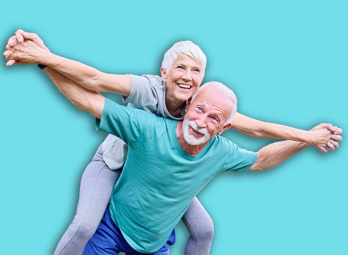 Smiling active senior couple having fun together in the park, active healthy elderly people bonding, older couple happy relationship
