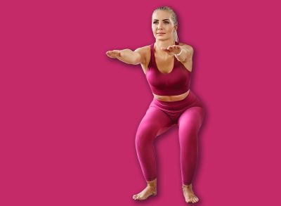 Young woman exercising at home doing squat