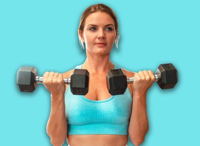 blonde girl doing biceps curls at the gym