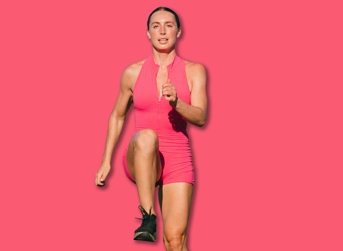 Female track athlete doing drills on grass