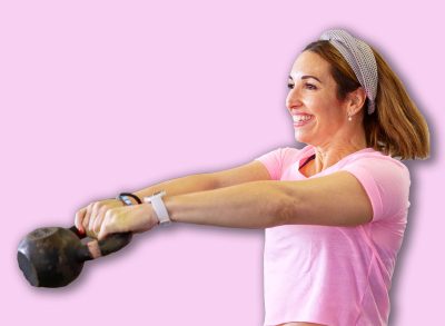 Women lifting kettlebells during a fitness class, building strength and staying active