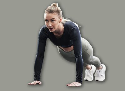 Fitness, push up and woman in gym for exercise, bodybuilder training and strong muscles. Healthy body, sports center and female person do pushup on floor for wellness, performance and cardio workout