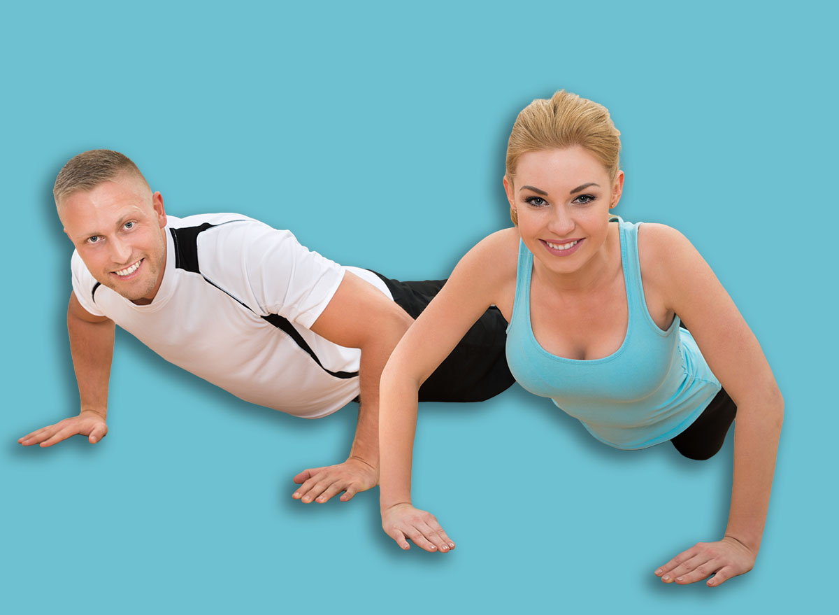 Portrait Of Happy Young Couple Doing Pushups