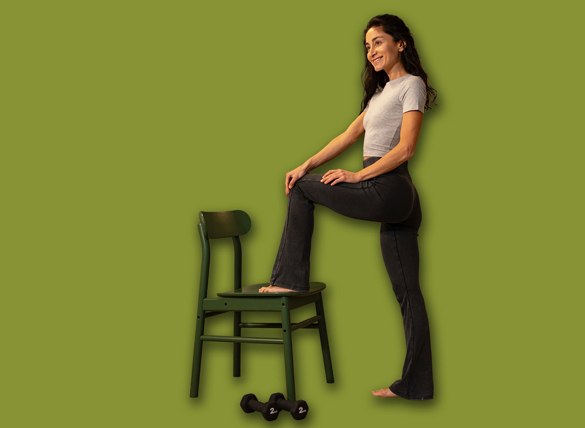 Active woman stretching leg on chair during home workout, functi