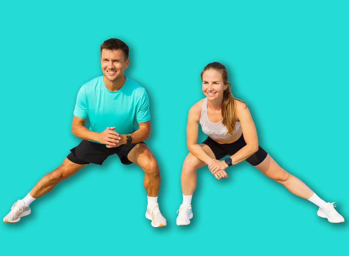 Two Individuals Perform Lateral Lunges Outdoors on a Sunny Day, Showcasing Fitness and Teamwork on Concrete Steps