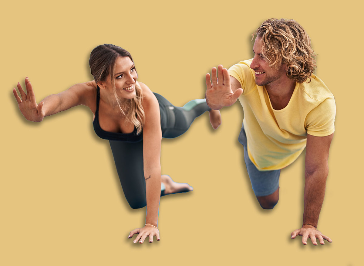 Man and woman couple smiling confident training abs exercise at sport center