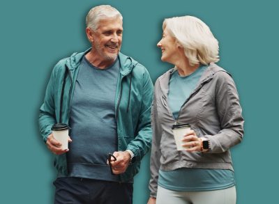 Coffee, old couple and walking dog in park together for outdoor fitness, health or wellness. Exercise, hobby or smile with senior man and woman training pet Labrador in nature for animal obedience
