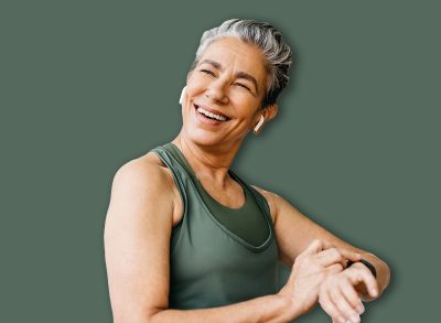 Retired woman using her smartwatch to track her fitness progress and stay connected while enjoying an outdoor workout. Happy senior woman taking advantage of technology to stay active and healthy.
