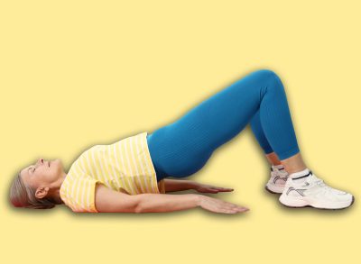 Senior woman exercising on mat at home. Fitness and sport