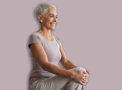 Cardio Workout. Cheerful Mature Woman Doing High Knees Exercise, Warming Up During Training In Living Room, Standing And Lifting Leg Up To Chest, Stretching Hamstring Muscles