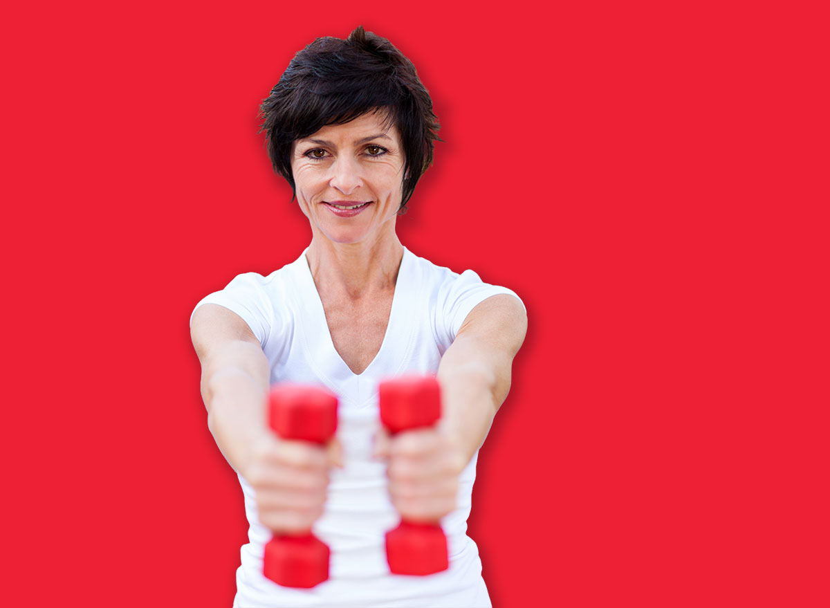 active middle aged woman exercise with dumbbells
