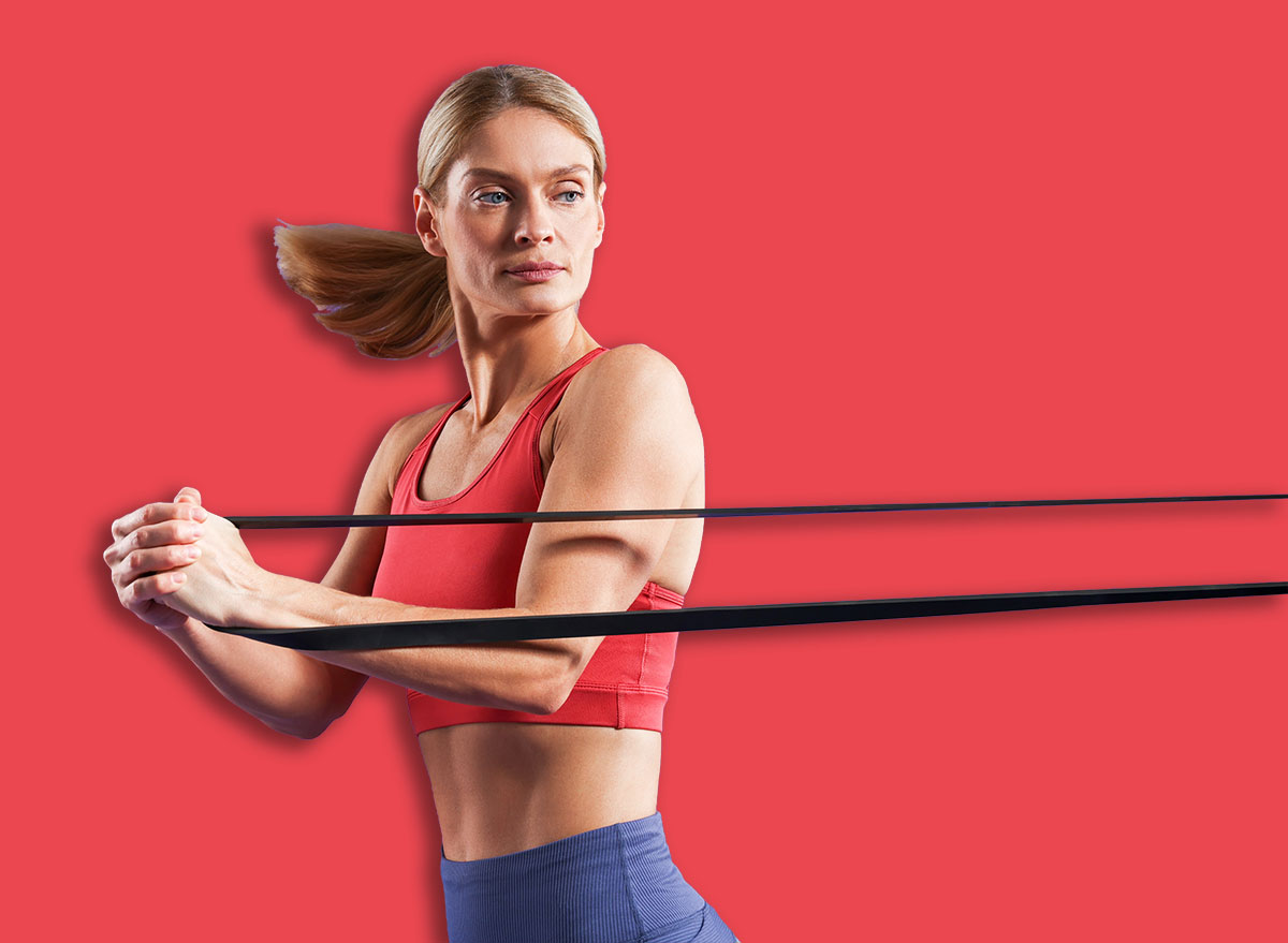 Athletic woman exercising with elastic resistance band on purple background