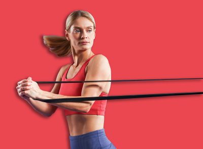 Athletic woman exercising with elastic resistance band on purple background