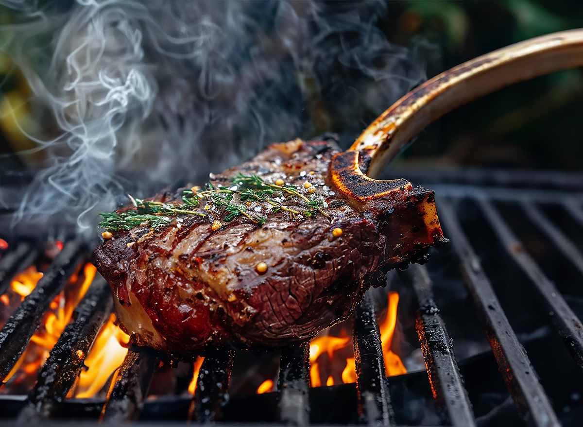 Steak being grilled on a charcoal grill