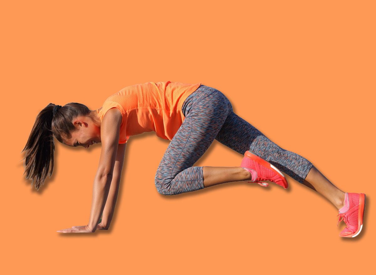 Fitness girl doing abs exercise to tone stomach muscles. Tiger curl reverse crunch planking bodyweight floor workout. Asian fit woman training outdoors on exercise mat. Gym lifestyle.