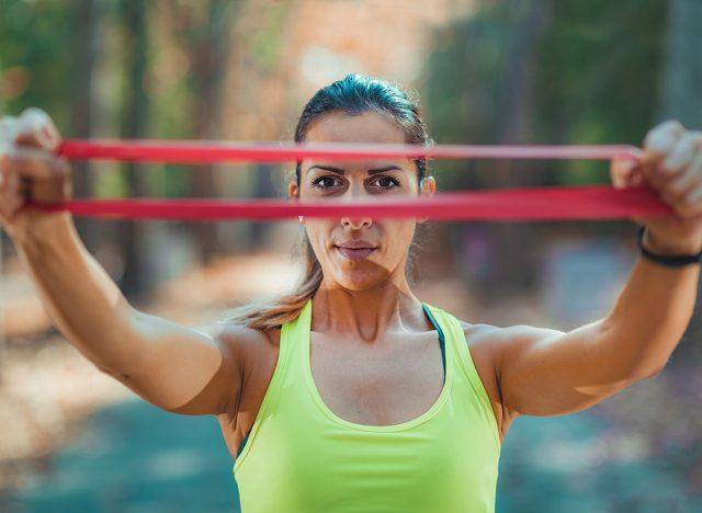 Woman Exercising with Resistance Band Outdoors