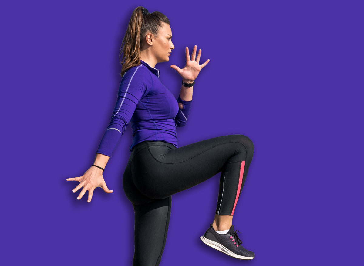 Young sweaty active sexy strong fit muscular woman climb with one knee leg high on the wall as outdoor body weight cross workout training with motion blur