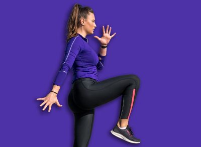 Young sweaty active sexy strong fit muscular woman climb with one knee leg high on the wall as outdoor body weight cross workout training with motion blur