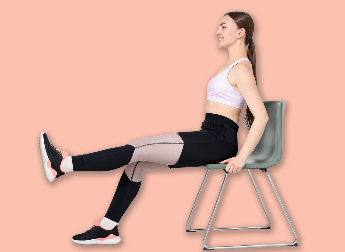 Beautiful woman exercising with chair at home