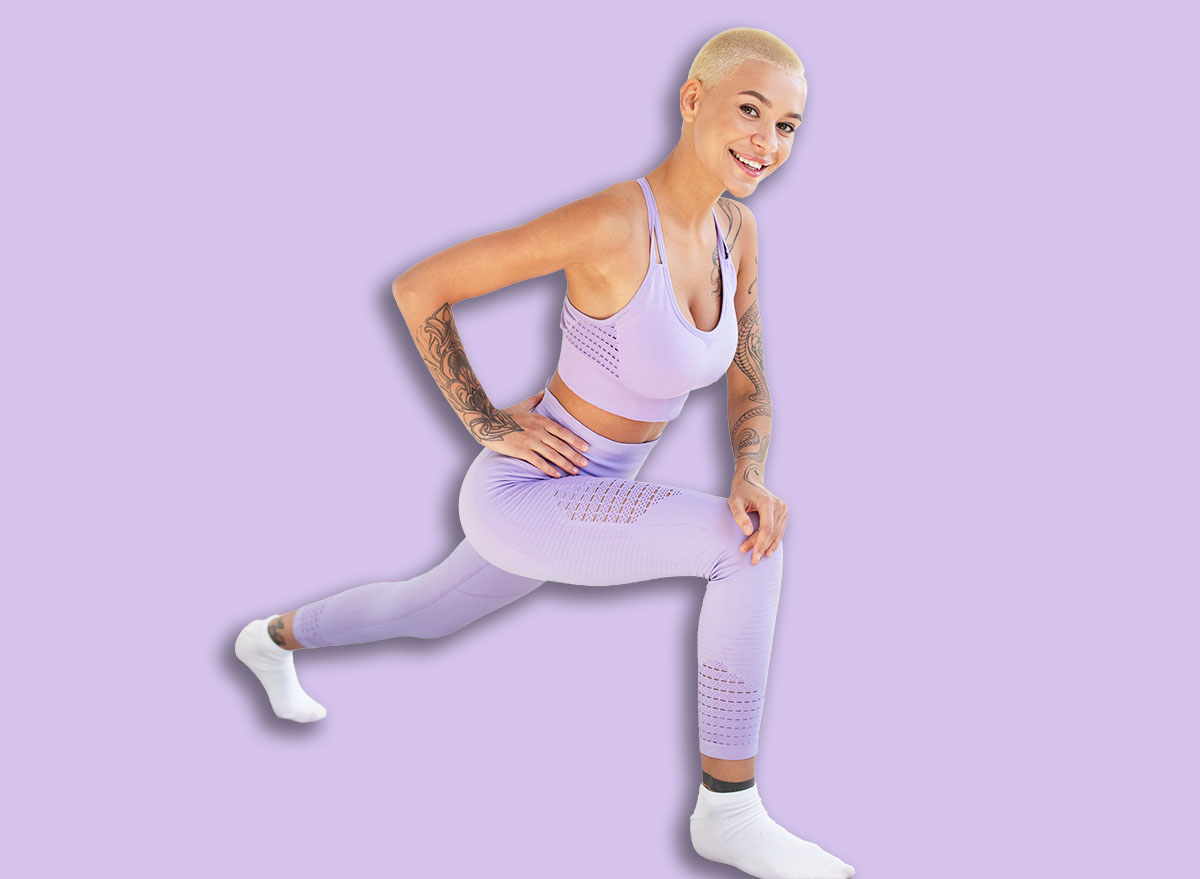 Fit lady making lunge, doing strength exercises, working out booty and legs muscles at home on yoga mat
