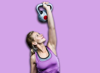 Portrait of woman holding kettlebell in crossfit