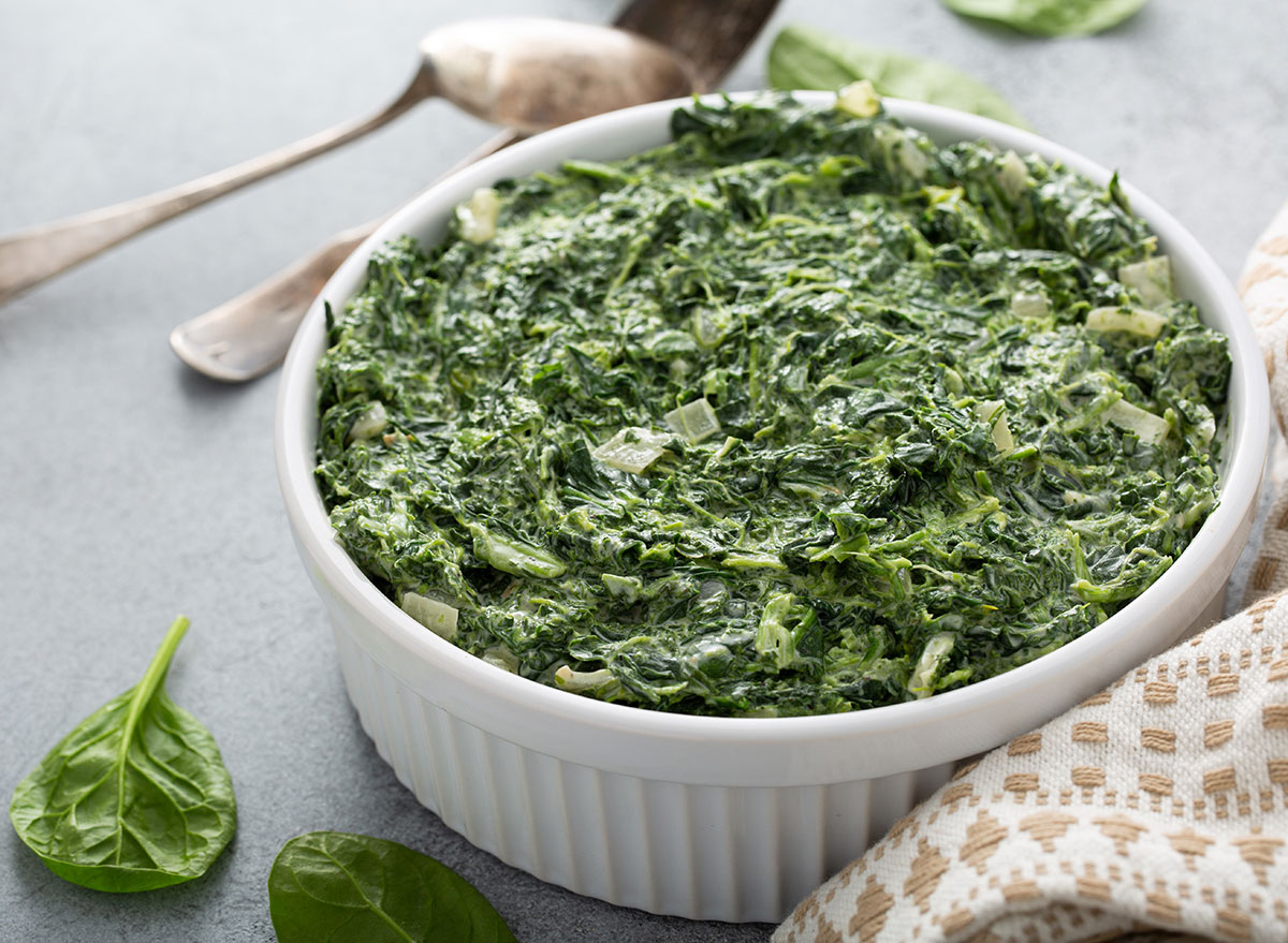 Creamed spinach with garlic in a white bowl