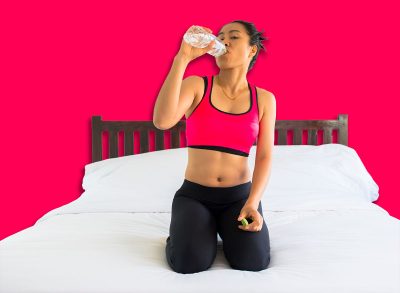 Women hold water bottles sitting in bed.