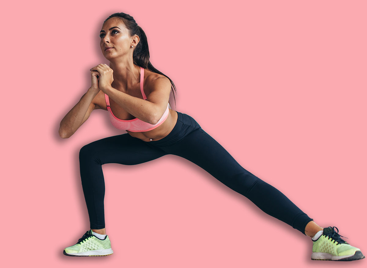 Two fit girls doing home workout performing lateral lunges at home