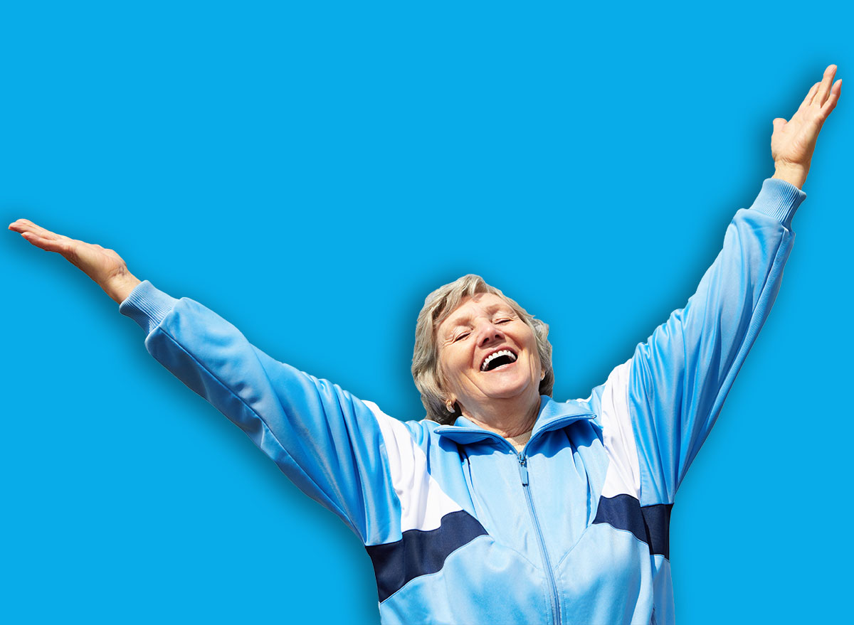 Portrait of mature woman with her arms raised outside