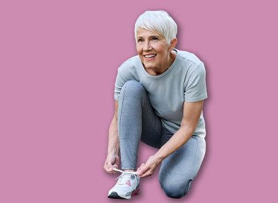 Portrait of a happy active elderly senior woman posing fixing shoelace lace on his running shoe after exercising outdoors, vitality and active senior concept