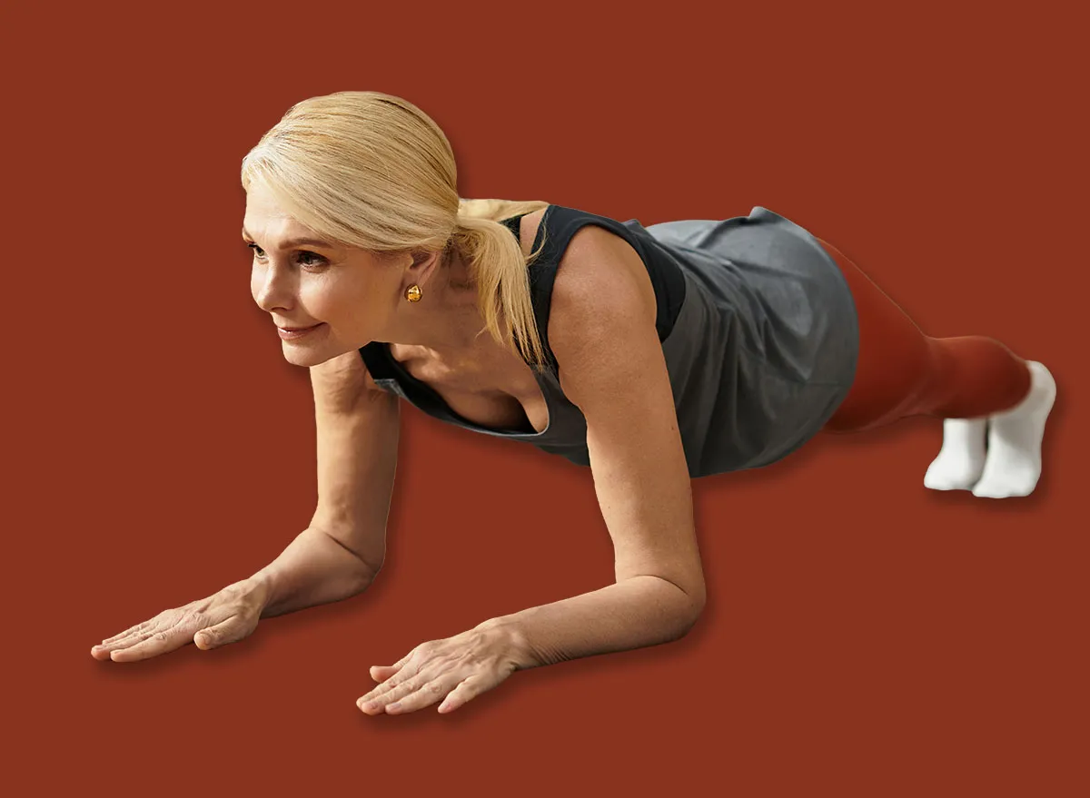 In a warm and inviting living room, a senior woman engages in yoga poses to enhance her well being.