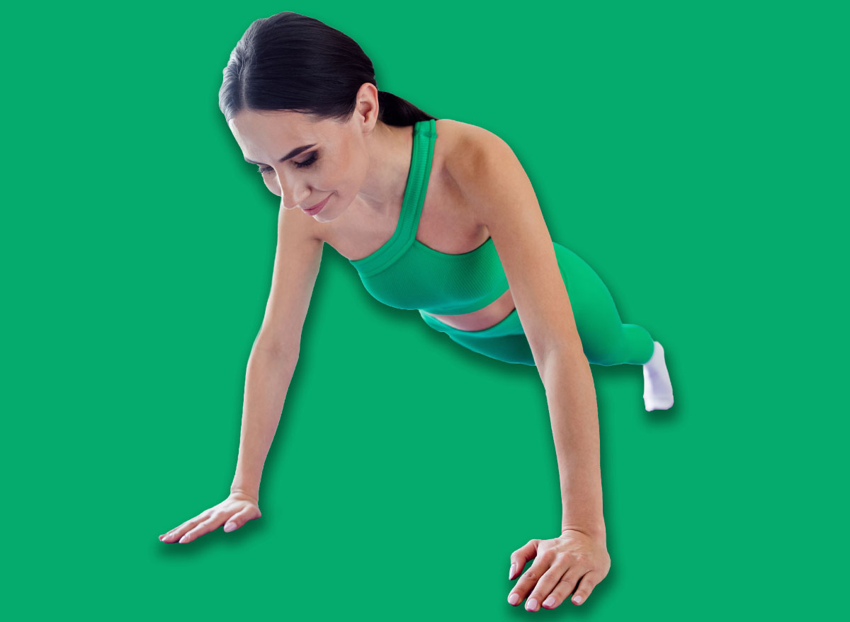 Full size portrait of great shape fitness coach girl doing plank stand push ups fitness carpet morning workout modern flat indoors