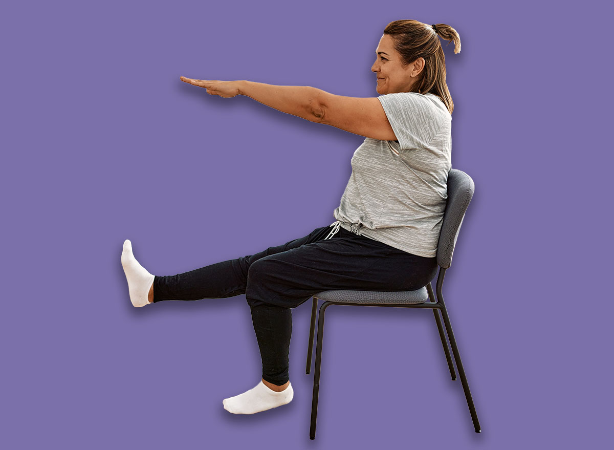 Middle age hispanic couple stretching using chair at sport center.
