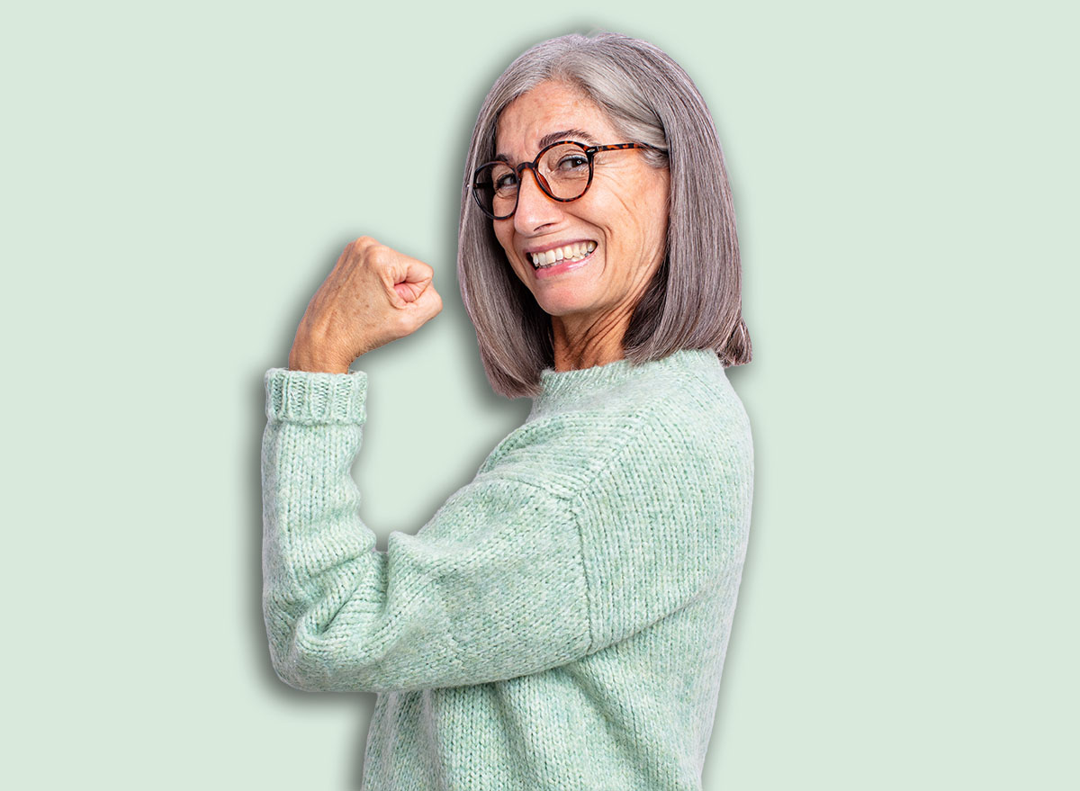 senior pretty woman feeling happy, satisfied and powerful, flexing fit and muscular biceps, looking strong after the gym