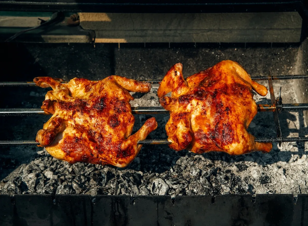 Two,Pieces,Of,Chicken,Are,Being,Cooked,On,A,Grill.