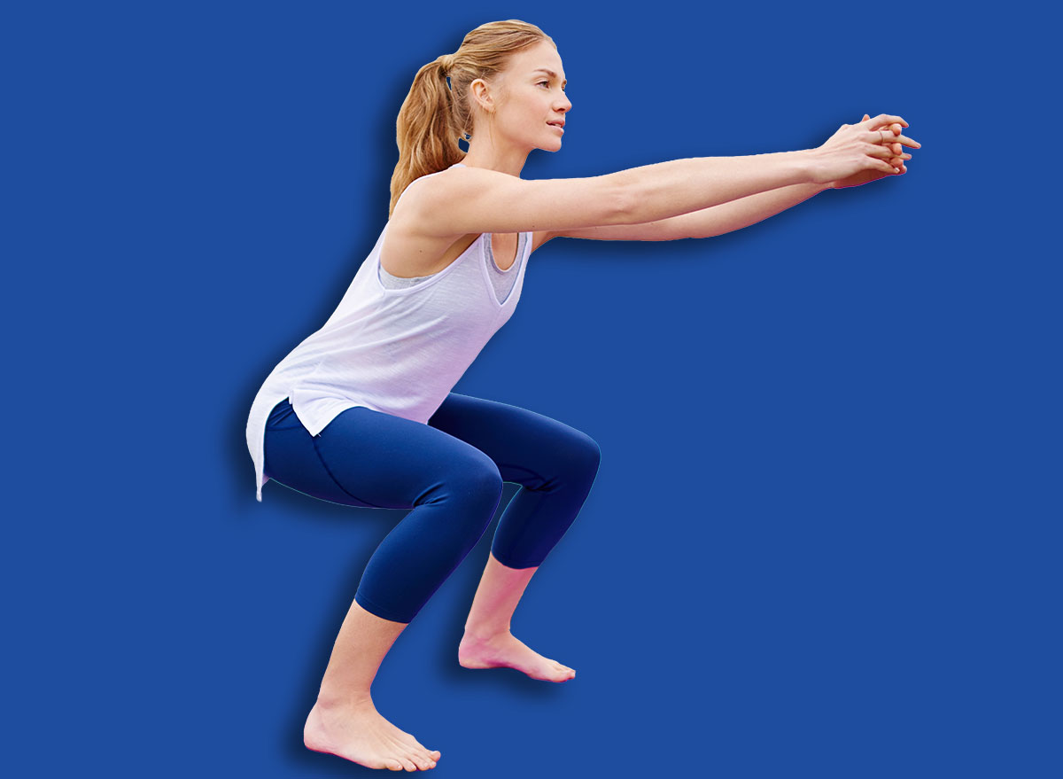 Fitness, woman and workout with squats outdoor for exercise, training and physical activity with balance. Person, stretching and practice on yoga mat at lake for endurance, healthy body and wellness