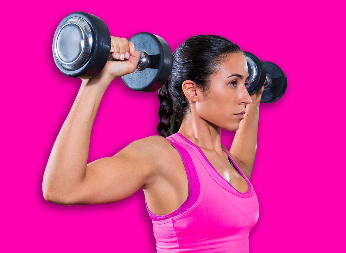 girl at gym seated dumbbell shoulder press workout exercise