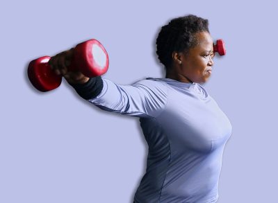 Person exercising with dumbbells in gym