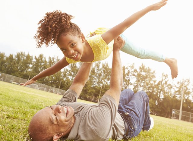Grandfather Playing Game With Granddaughter In Park