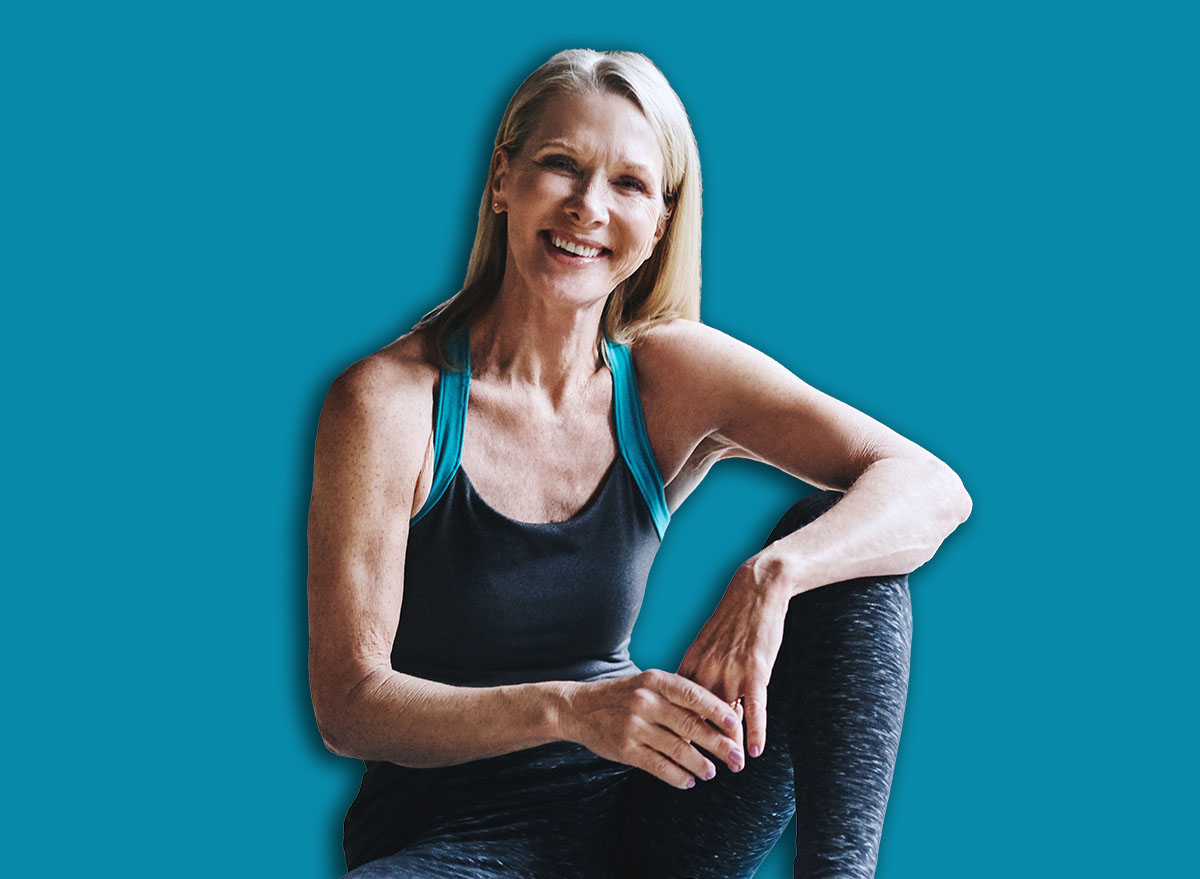 Fitness, portrait and senior woman on yoga mat for break, wellness and recovery in gym. Exercise club, rest and happy elderly person on floor for relax, self care and pilates cool down in studio