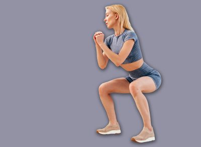 Young woman practicing squats. Woman exercising at home.