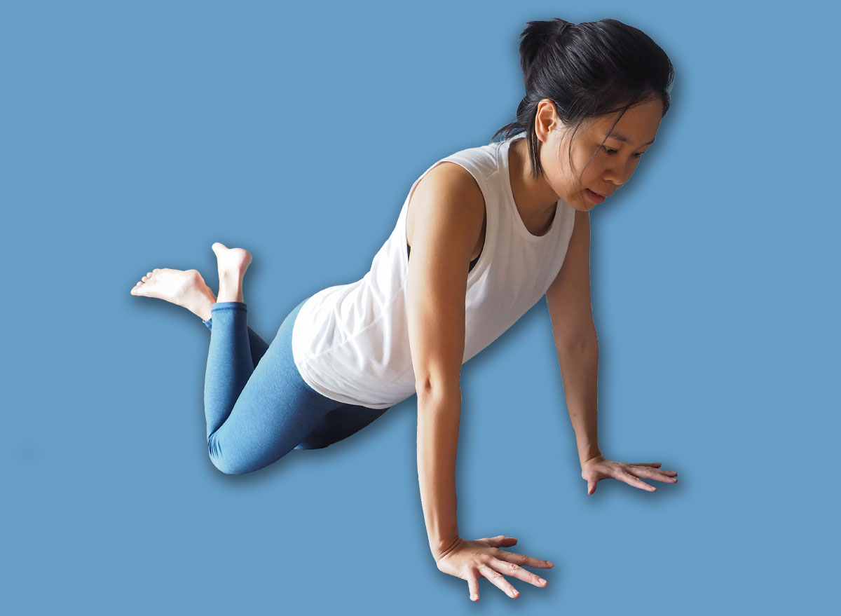 asian woman workout fitness knee push up plank pose home yoga training with tablet computer smart phone for healthy wellness care on mat natural light selective focus