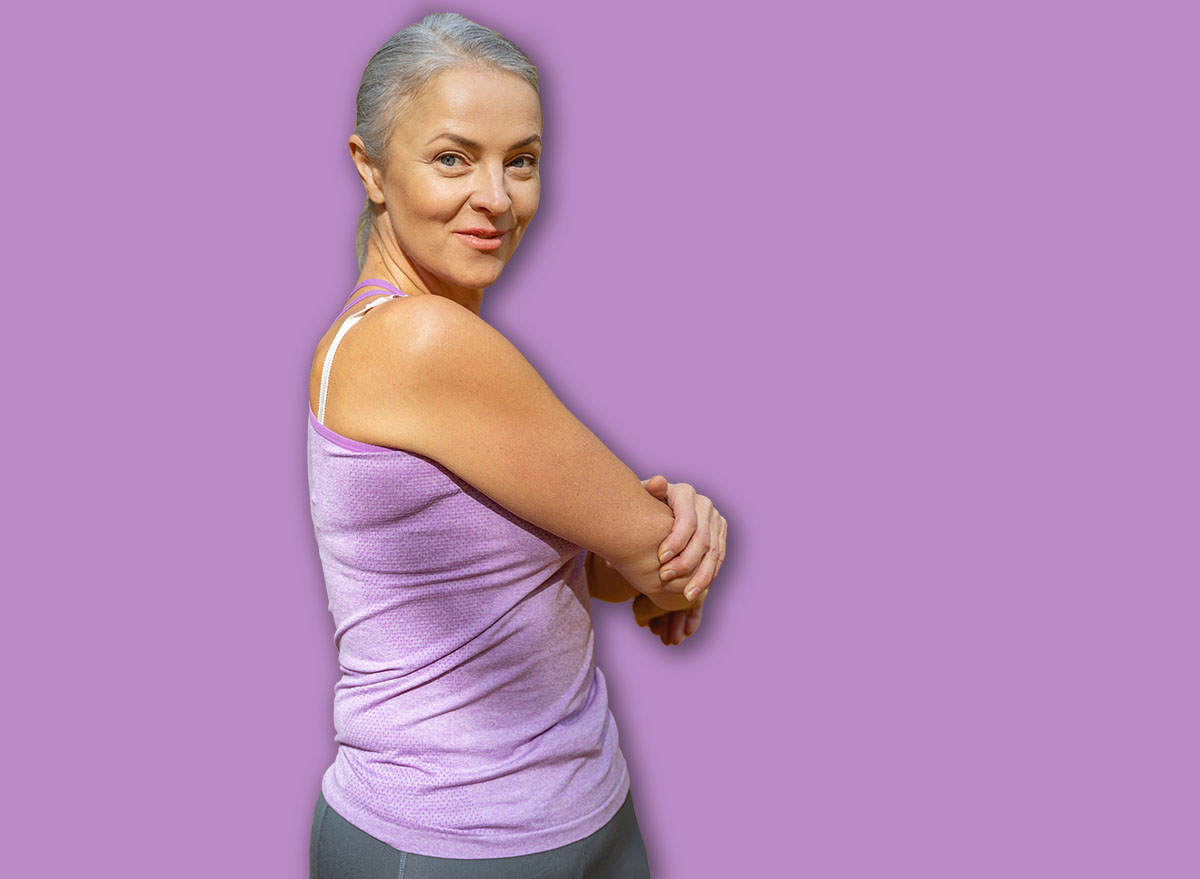 Positive fit Caucasian female stretching her arms