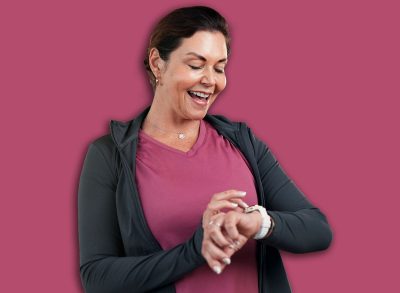 Check, smart watch and mature woman in gym, fitness and tracking workout progress on app and online. Health club, info and person with exercise goals, wellness and monitor heart rate with technology