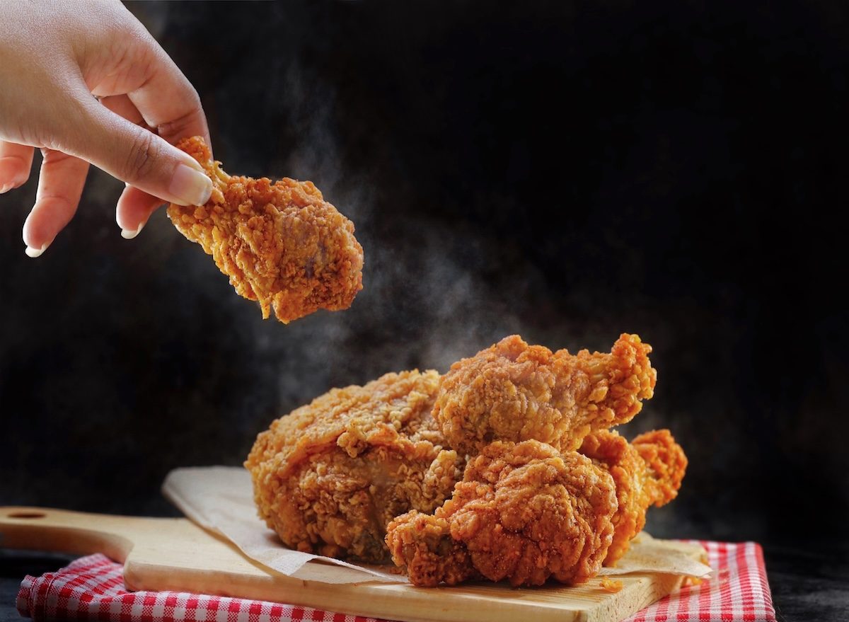 Close,Up,Woman,Hand,Holding,Spicy,Fried,Chicken,Wing,Over