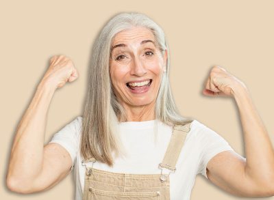 senior pretty woman feeling happy, satisfied and powerful, flexing fit and muscular biceps, looking strong after the gym