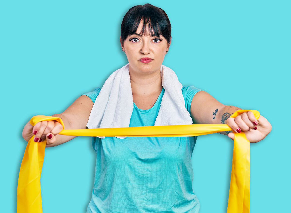 Young hispanic woman wearing sportswear and arm band relaxed with serious expression on face. simple and natural looking at the camera.