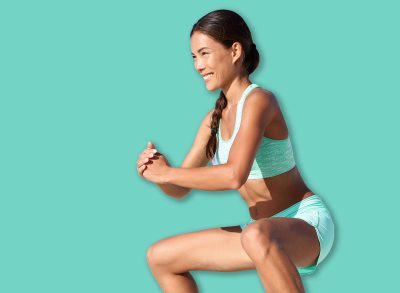 Fitness woman doing bodyweight workout training calves with plie squat calf raise exercise. Asian sport girl doing a ballet inspired ballerina pose to activate glutes and lower body by raising heels.