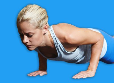 Athlete, fitness and woman in gym, push ups and workout for body strength with endurance and health. Training, bodybuilder and person on floor with balance, wellness and exercise for muscle gain